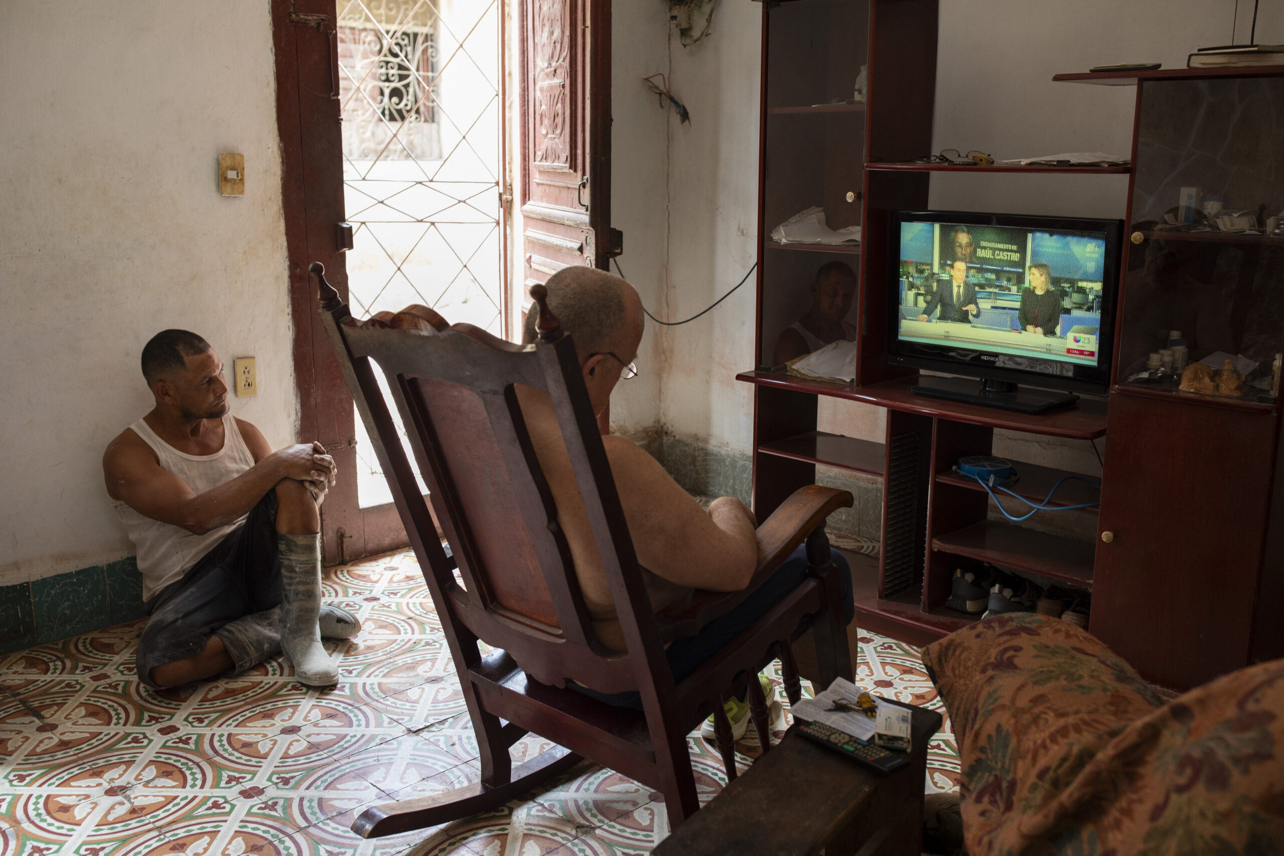 A woman walks into a furniture workshop with images of, from left, Fidel Castro, the Cuban flag, Raúl Castro, and Che Guevara, right, in Havana, on Wednesday, May 20, 2026. The U.S. Justice Department on Wednesday unsealed an indictment against Raúl Castro, the 94-year-old former president of Cuba, charging him with murder and a conspiracy to kill U.S. citizens stemming from the fatal downing 30 years ago of two planes. (Lisette Poole/The New York Times)