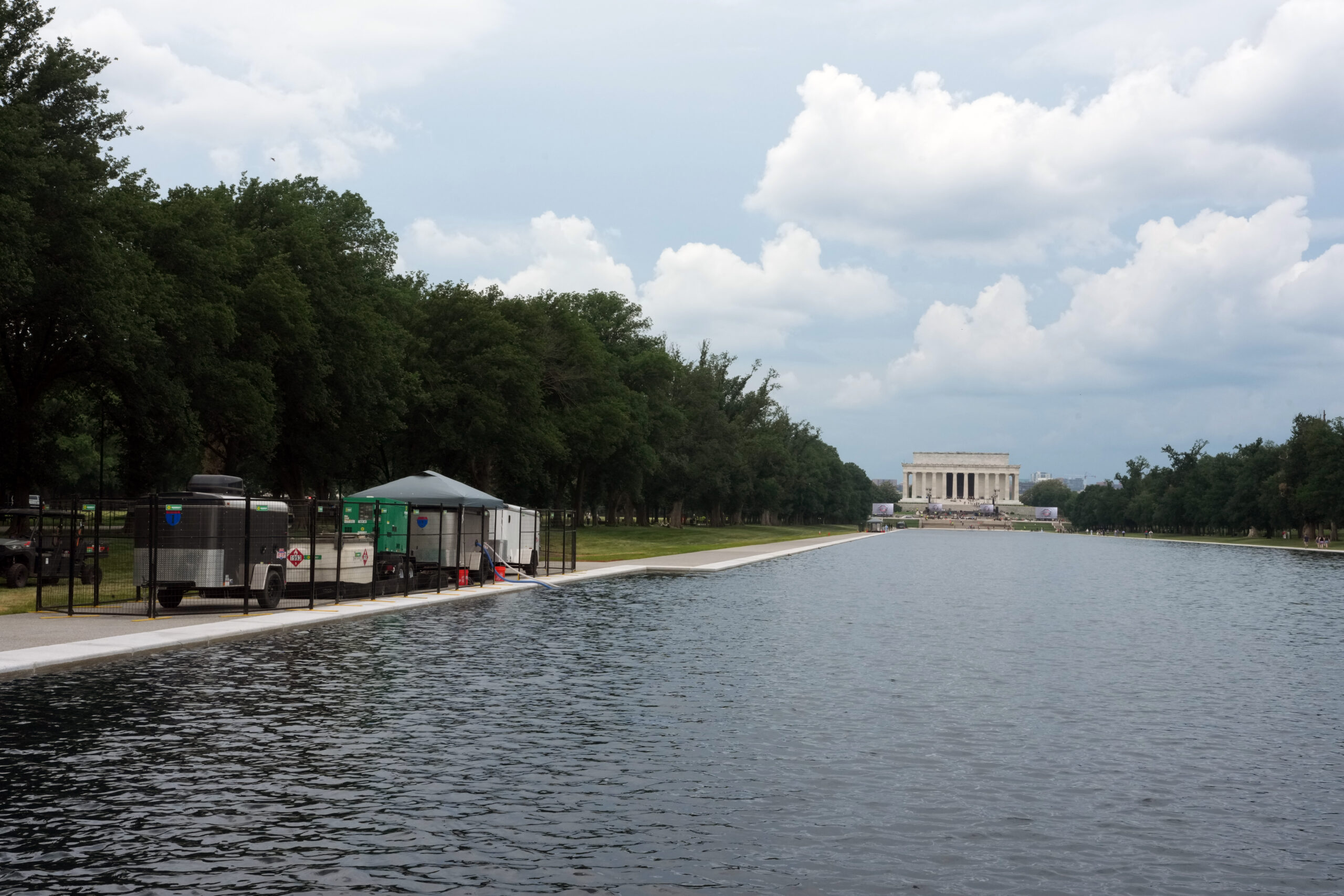 Blue paint peels from the basin of the Lincoln Memorial Reflecting Pool and floats atop algae-filled water during maintenance work in Washington on Thursday, June 18, 2026. The Trump administration gave a no-bid contract to clean the Lincoln Memorial Reflecting Pool's water to Greenwater Services, a firm tied to one of President Donald Trump's political donors, records show. (Salwan Georges/The New York Times)