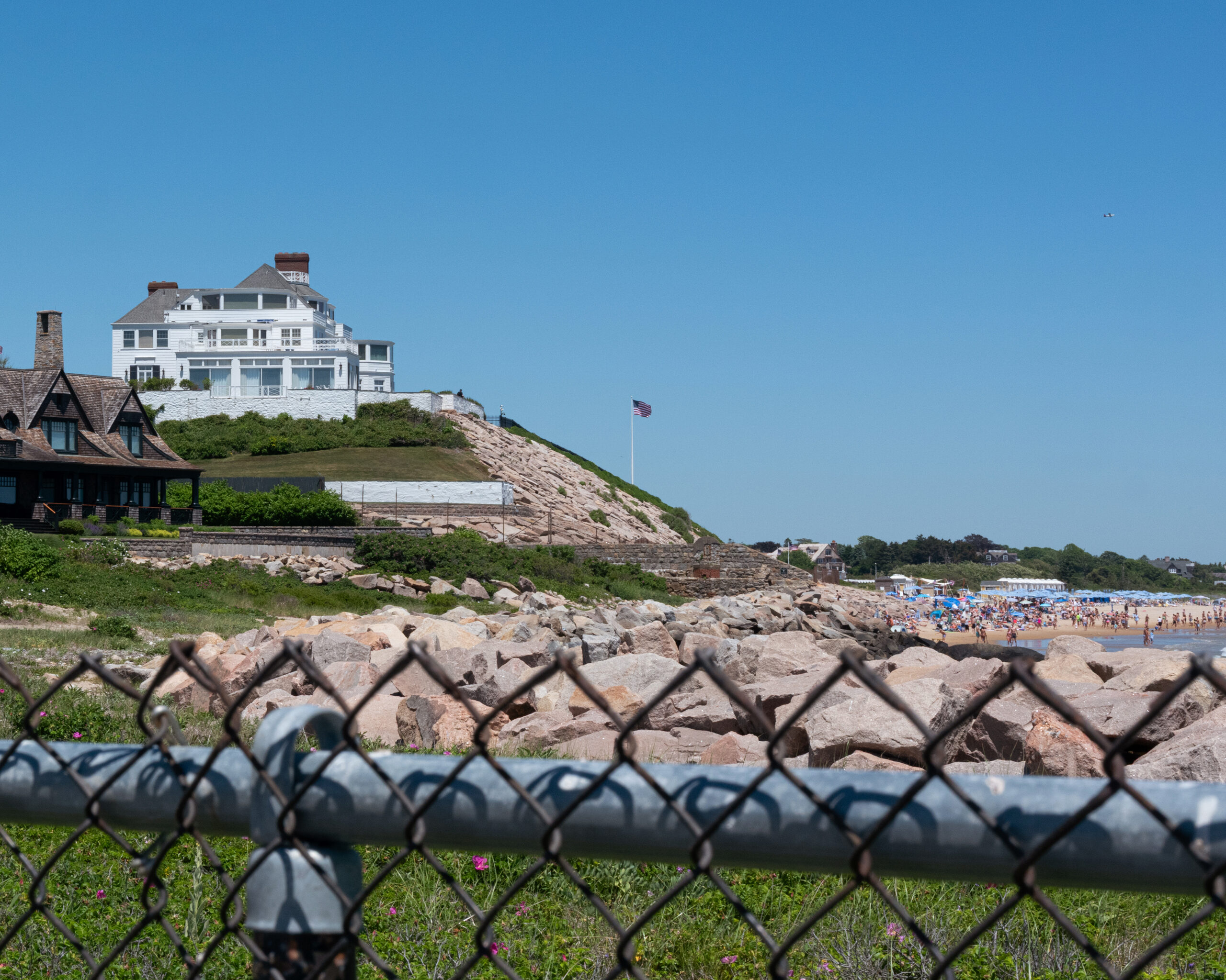 Holiday House, top left, which Taylor Swift purchased in 2013, sits atop the titular hill in the Watch Hill neighborhood of Westerly, R.I., June 13, 2026. Public oceanfront sprawls out below it. (Sarah Meftah/The New York Times)