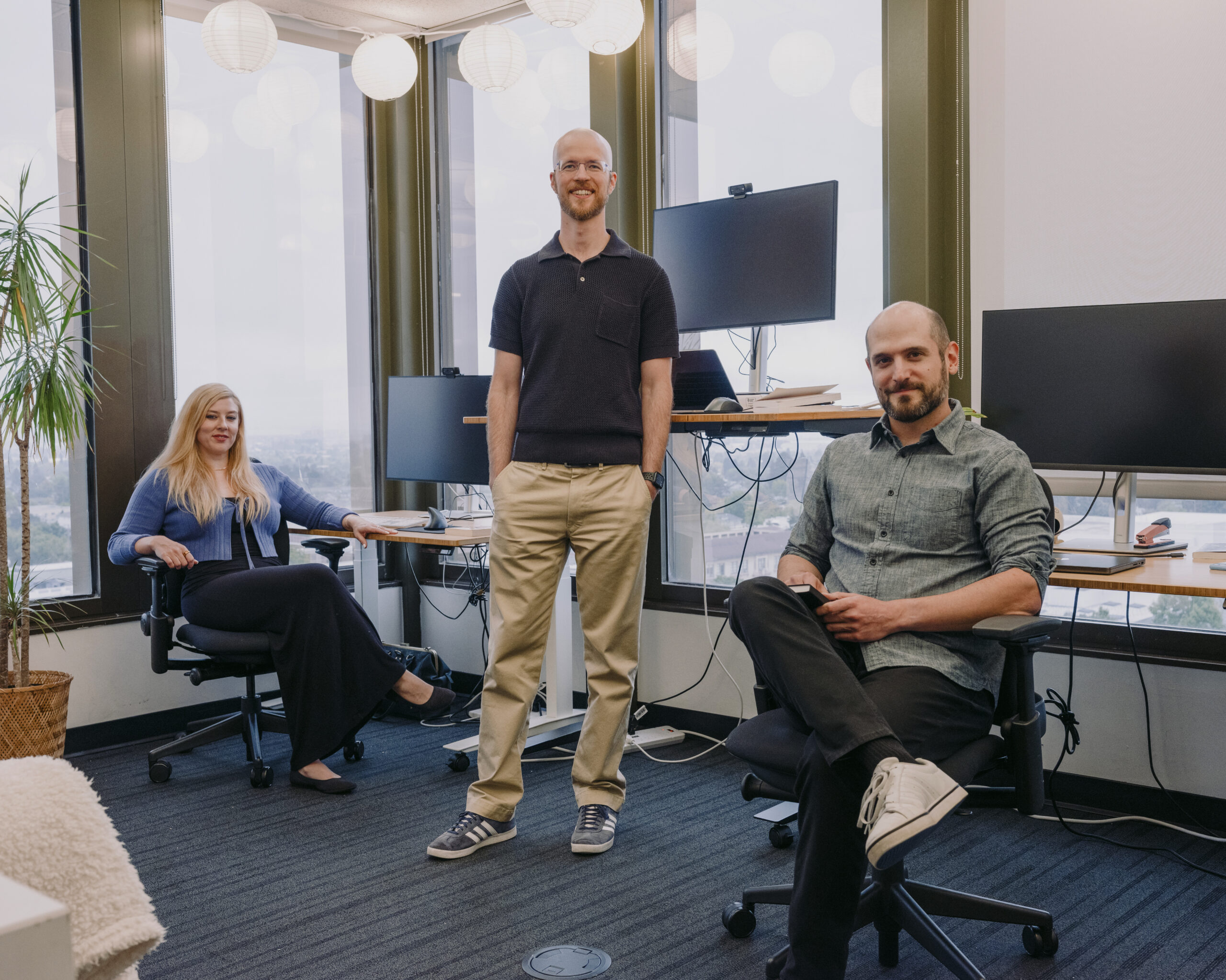 The Eleos AI Research team, from left: Rosie Campbell, Dillon Plunkett and Robert Long, at offices in Berkeley, Calif., June 26, 2026. Philosophy, one of humanity's oldest disciplines, and Artificial Intelligence, one of its newest inventions, feel distinctly made for each other. (Ian C. Bates/The New York Times)