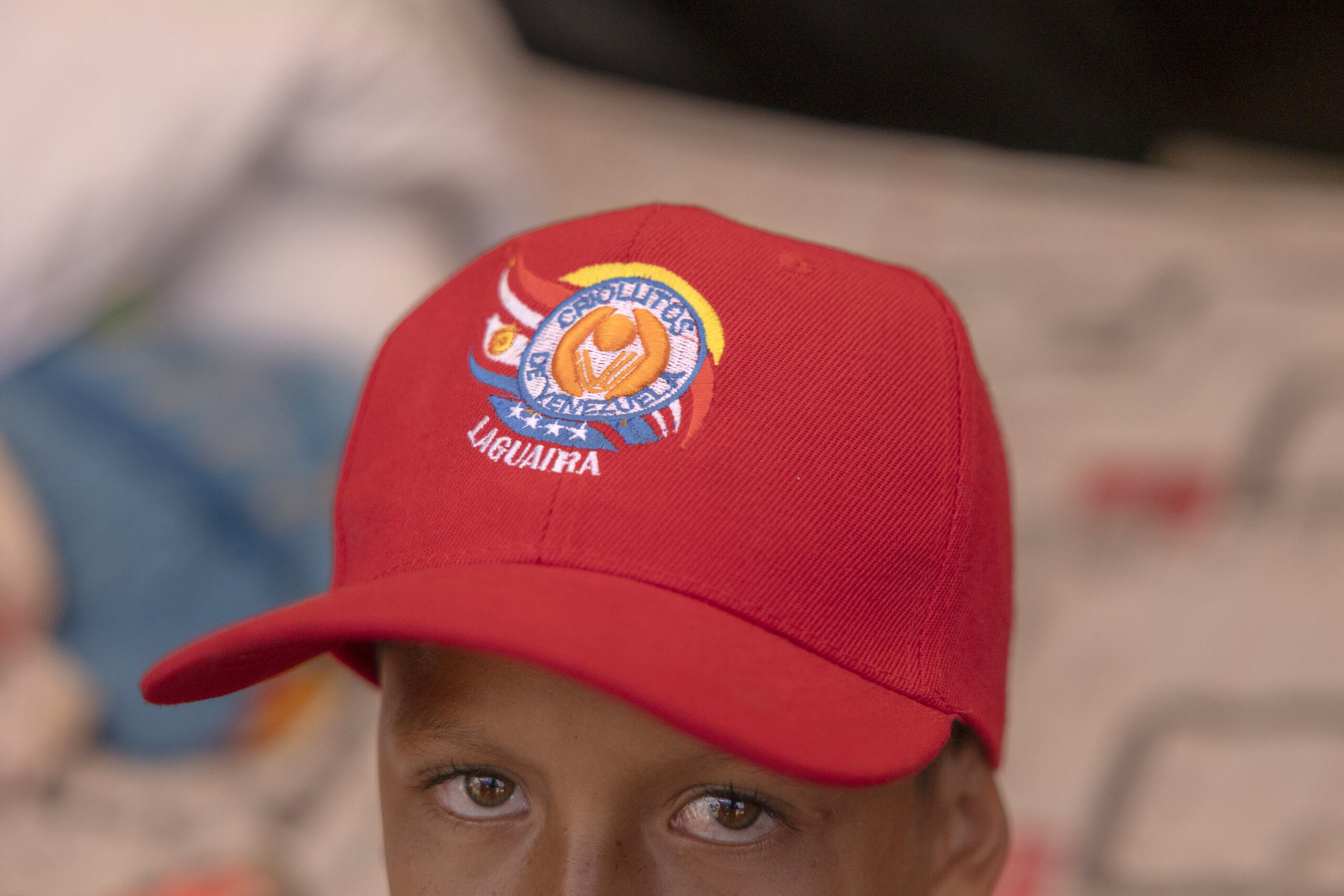 Raymer Flores, 10, inside a temporary shelter in La Guaira, Venezuela, on July 1, 2026. Flores lost his home and is sleeping under a tarp with his family at a baseball field in La Guaira. (Fabiola Ferrero/The New York Times)